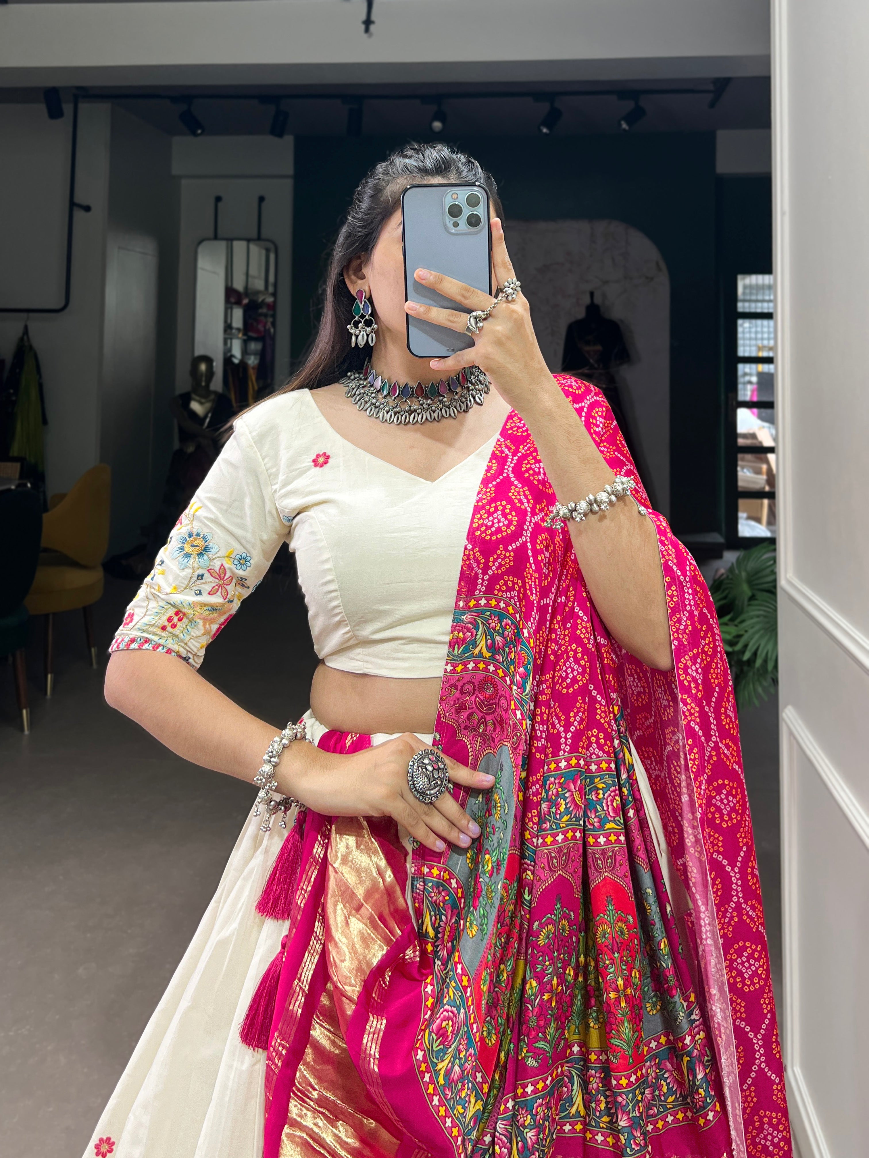 An elegant ivory lehenga made vibrant by a stunning multi-hued pink dupatta