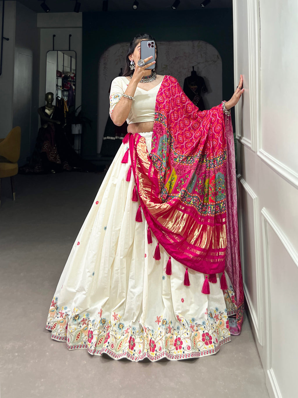An elegant ivory lehenga made vibrant by a stunning multi-hued pink dupatta