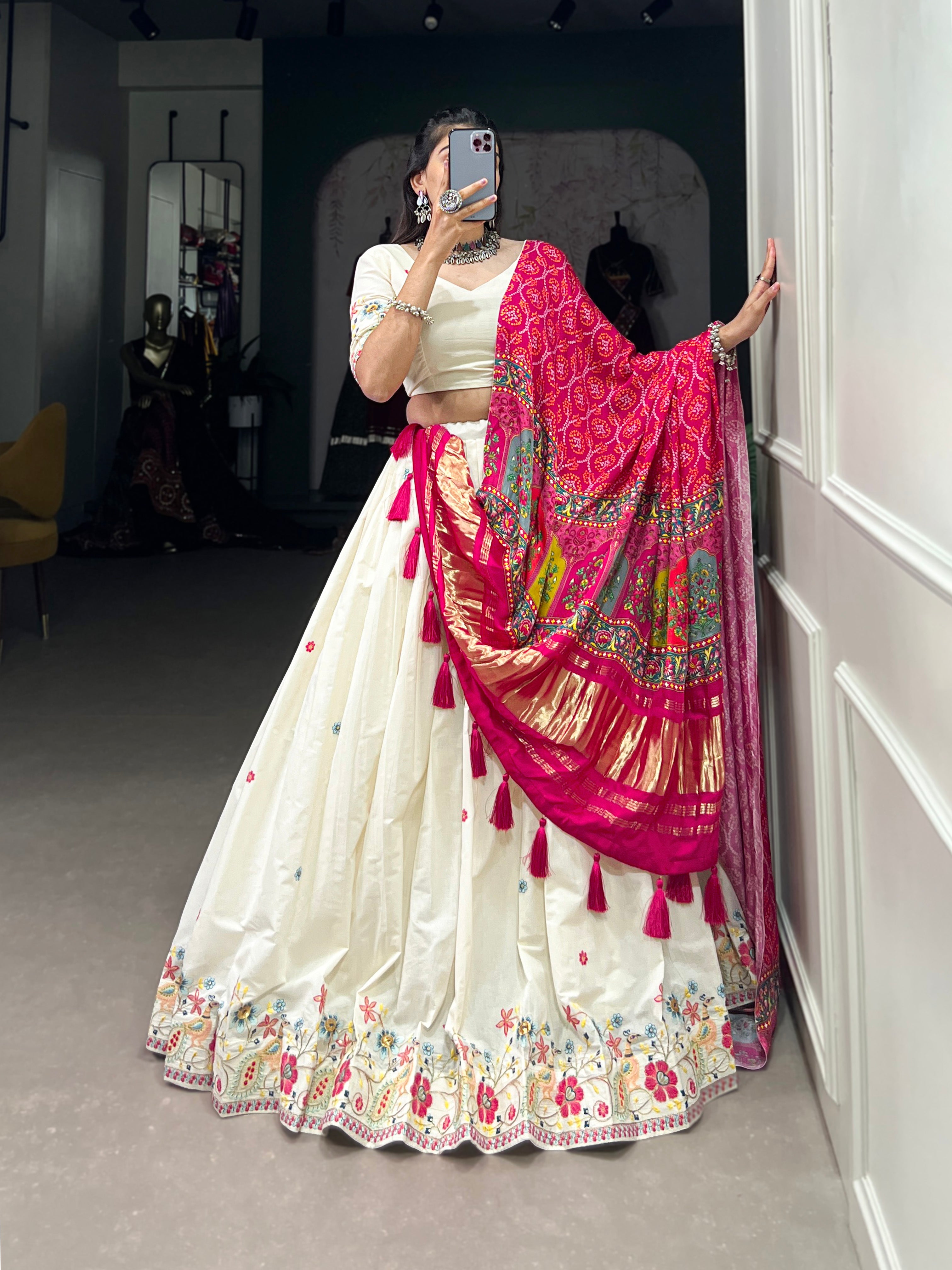 An elegant ivory lehenga made vibrant by a stunning multi-hued pink dupatta