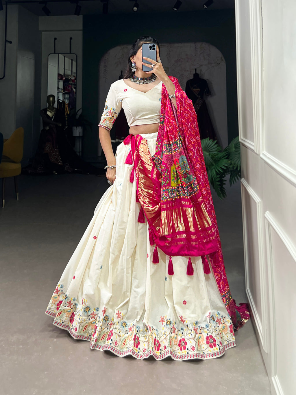 An elegant ivory lehenga made vibrant by a stunning multi-hued pink dupatta