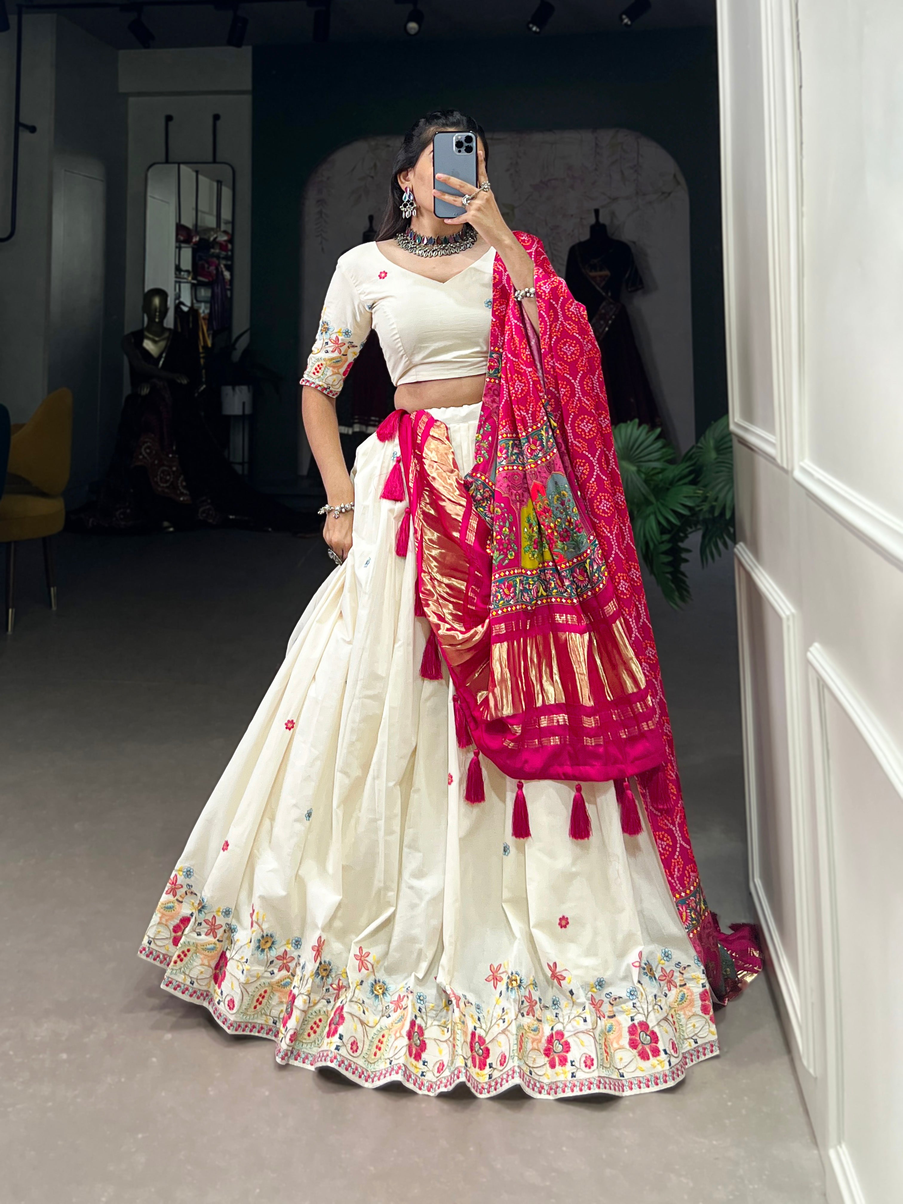 An elegant ivory lehenga made vibrant by a stunning multi-hued pink dupatta