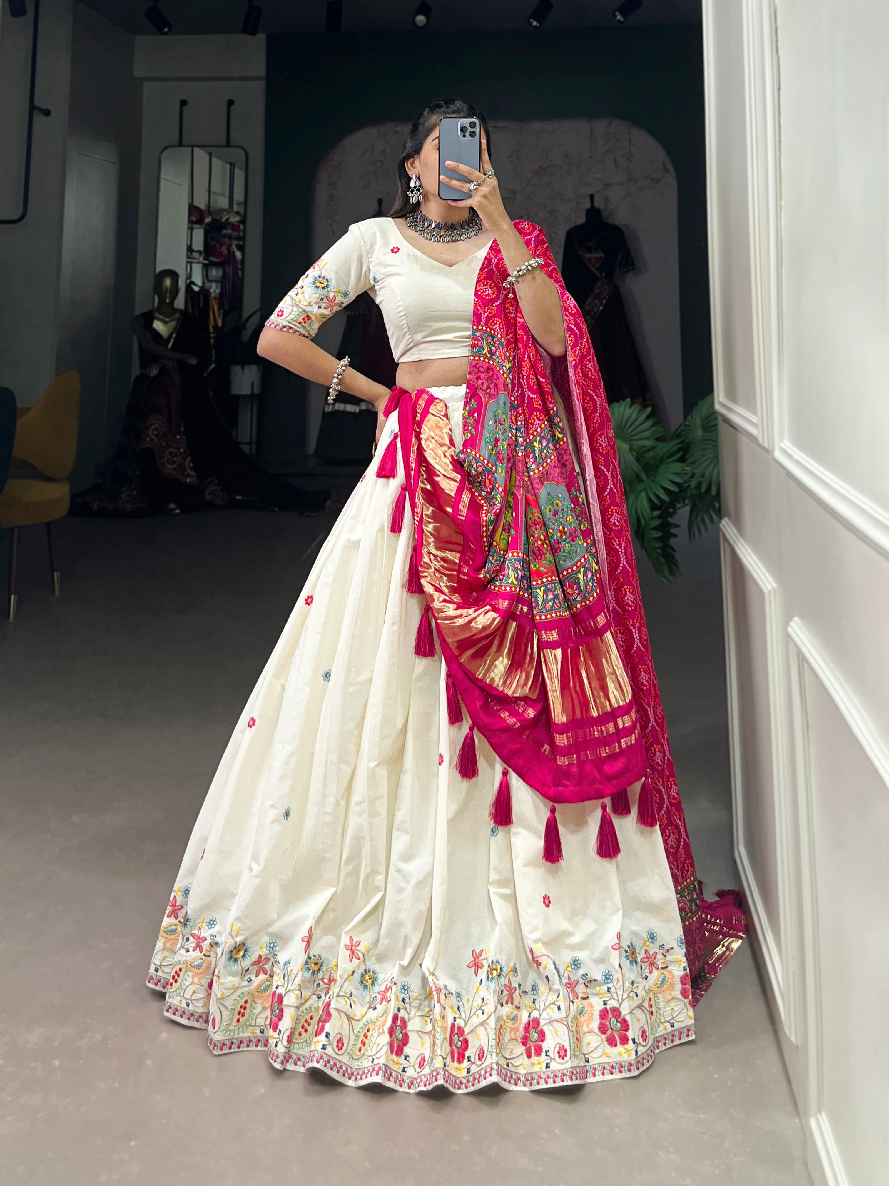 An elegant ivory lehenga made vibrant by a stunning multi-hued pink dupatta