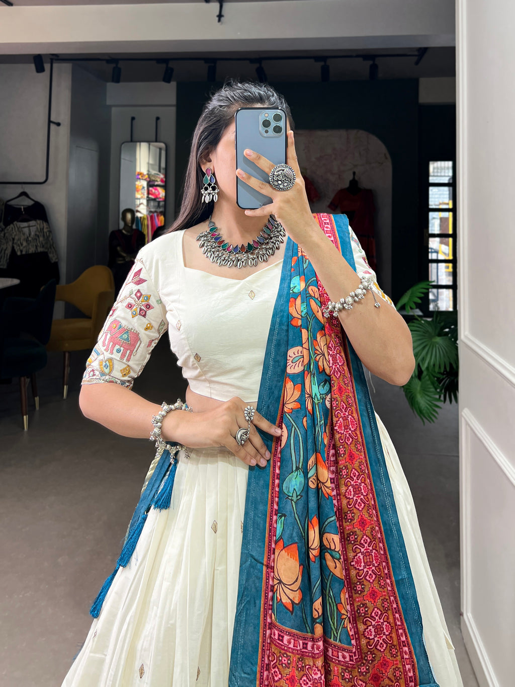 An elegant ivory lehenga made vibrant by a stunning multi-hued pink dupatta
