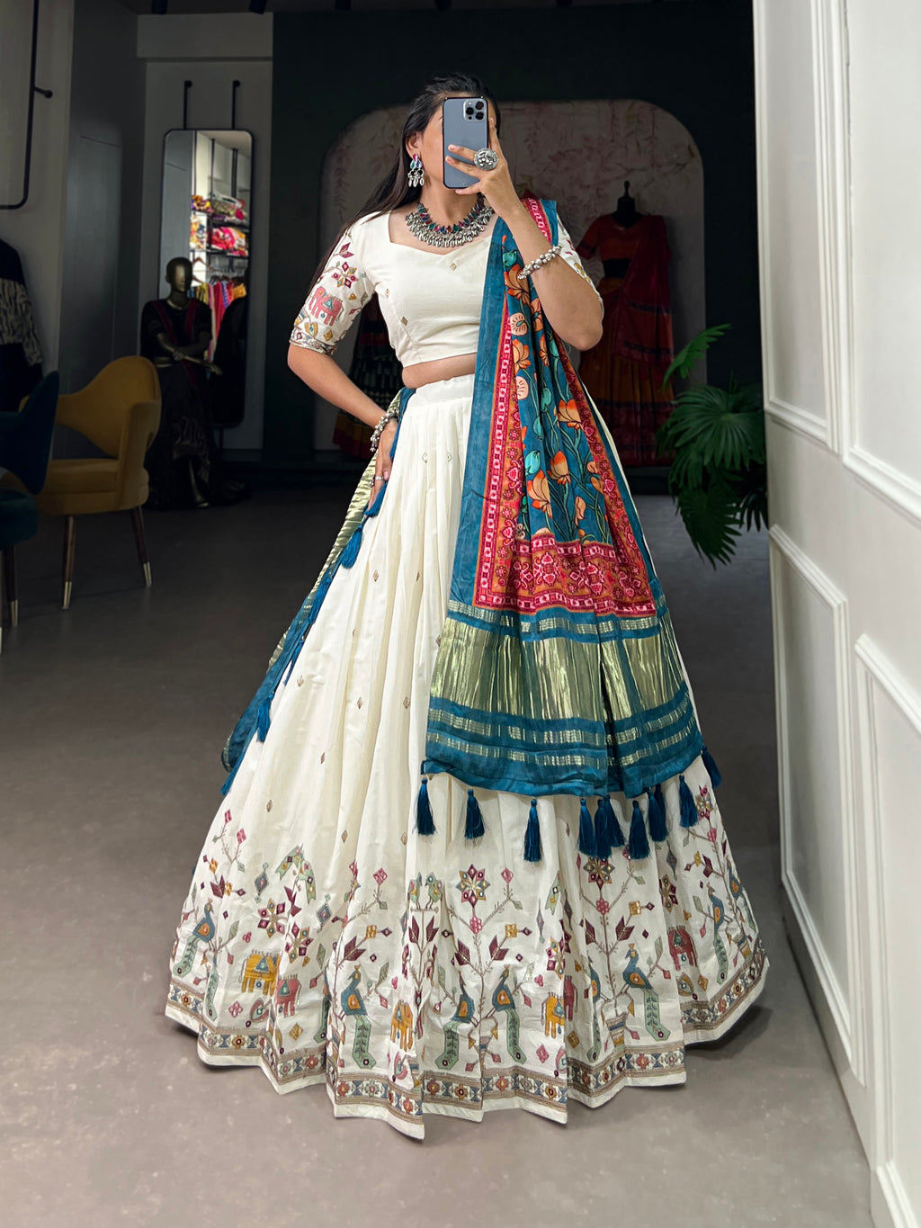 An elegant ivory lehenga made vibrant by a stunning multi-hued pink dupatta