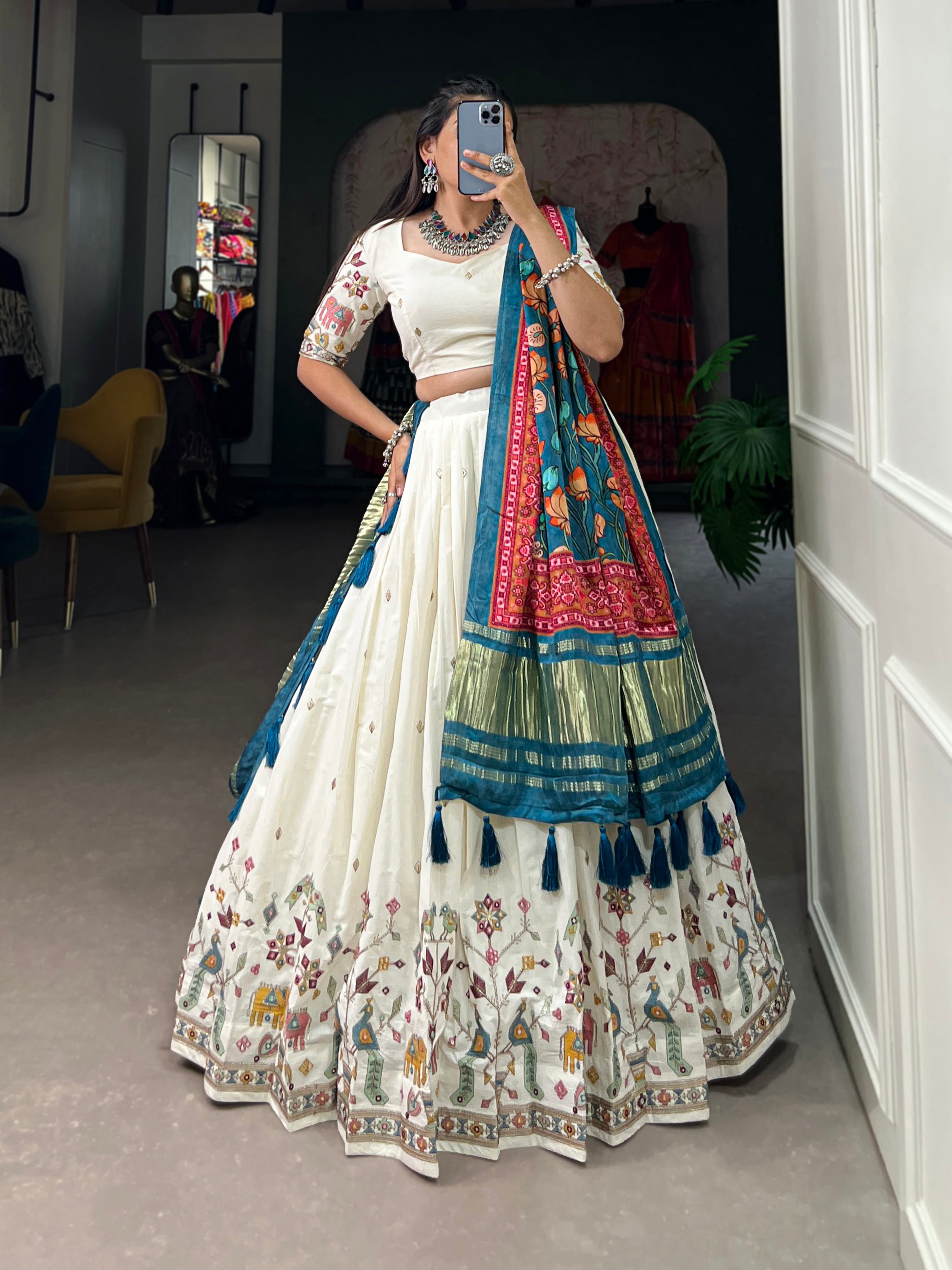An elegant ivory lehenga made vibrant by a stunning multi-hued pink dupatta