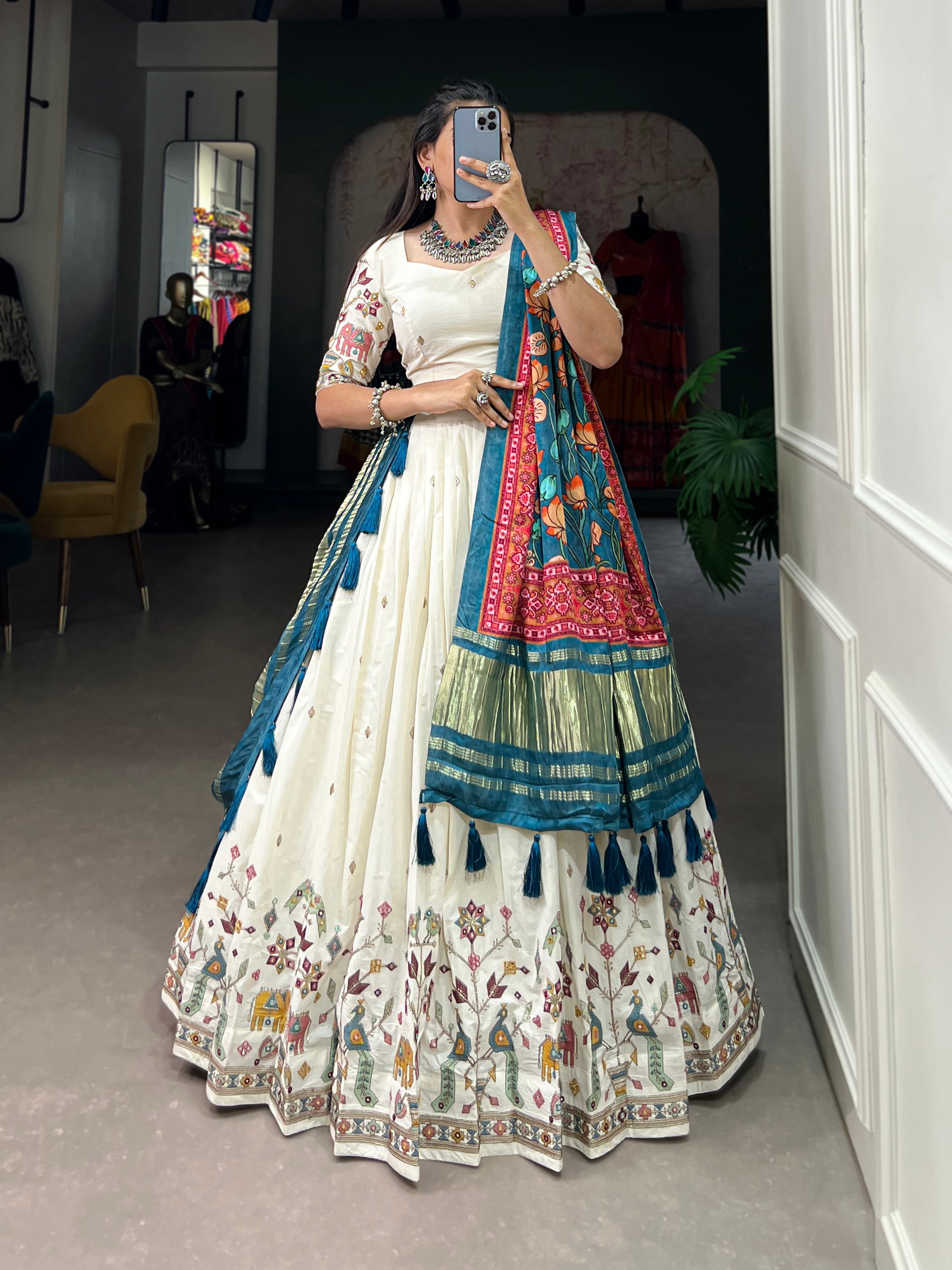 An elegant ivory lehenga made vibrant by a stunning multi-hued pink dupatta