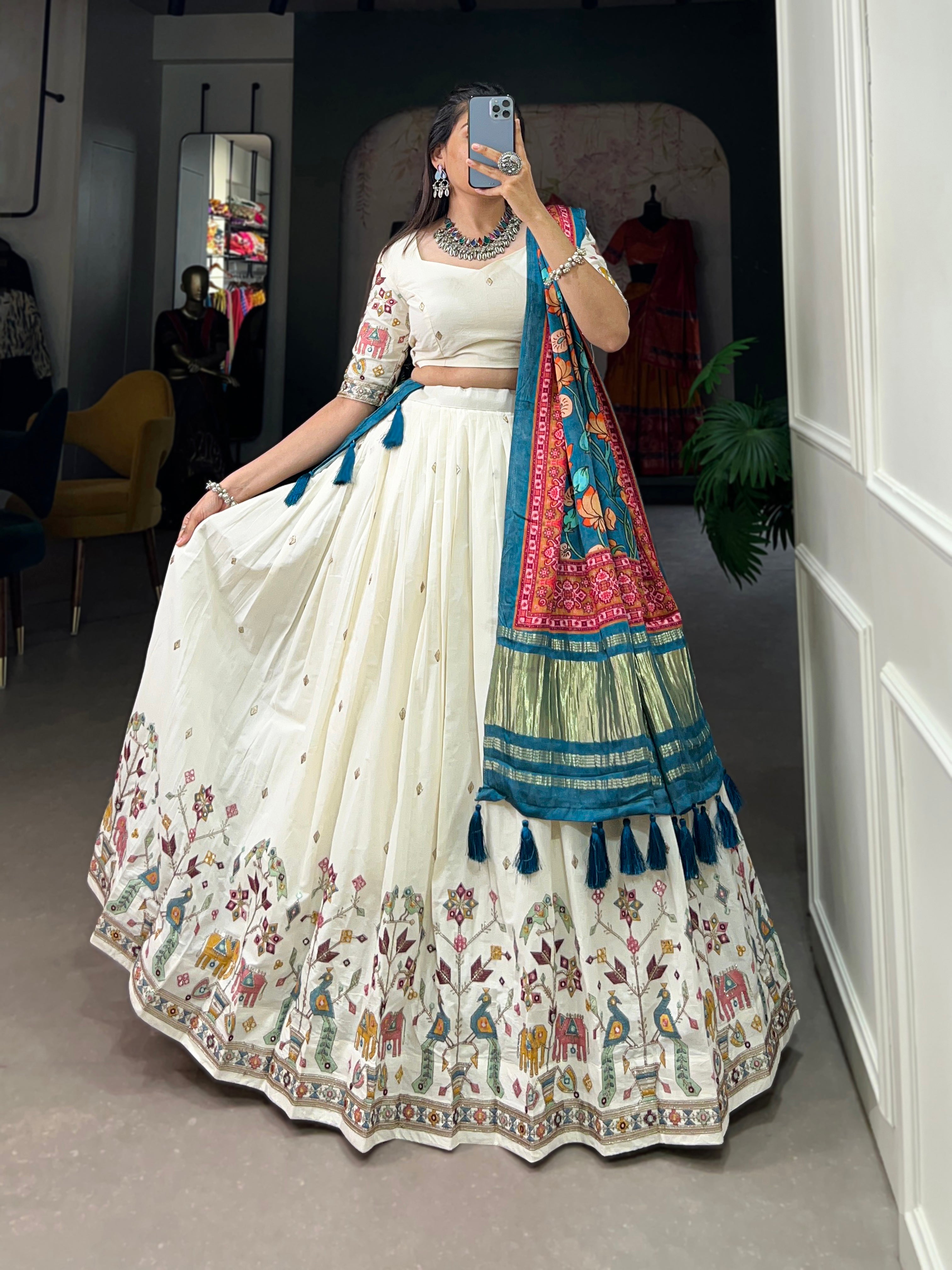 An elegant ivory lehenga made vibrant by a stunning multi-hued pink dupatta
