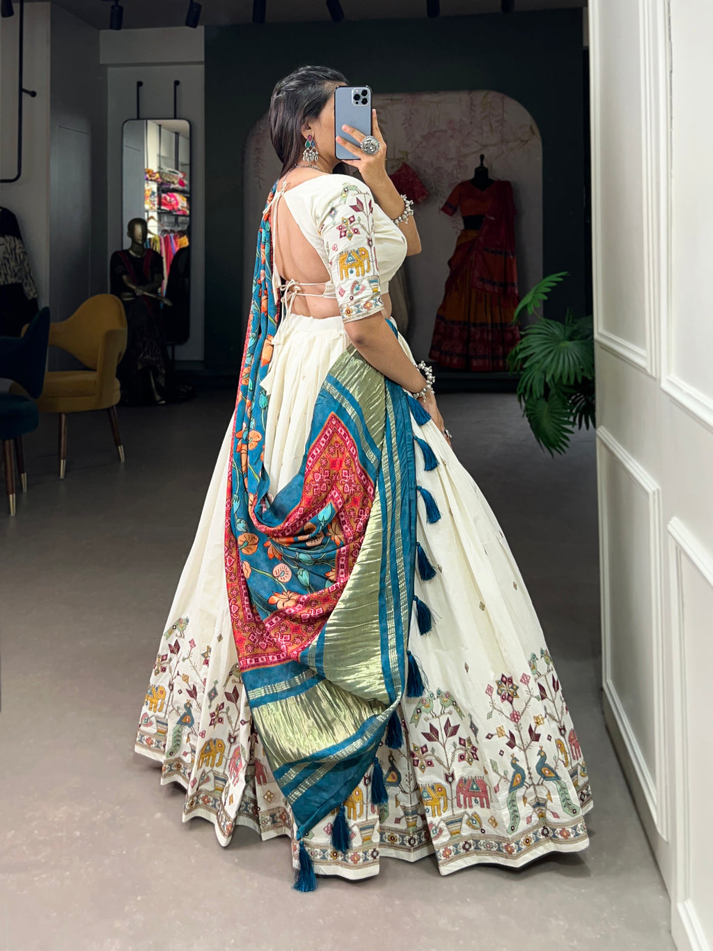 An elegant ivory lehenga made vibrant by a stunning multi-hued pink dupatta