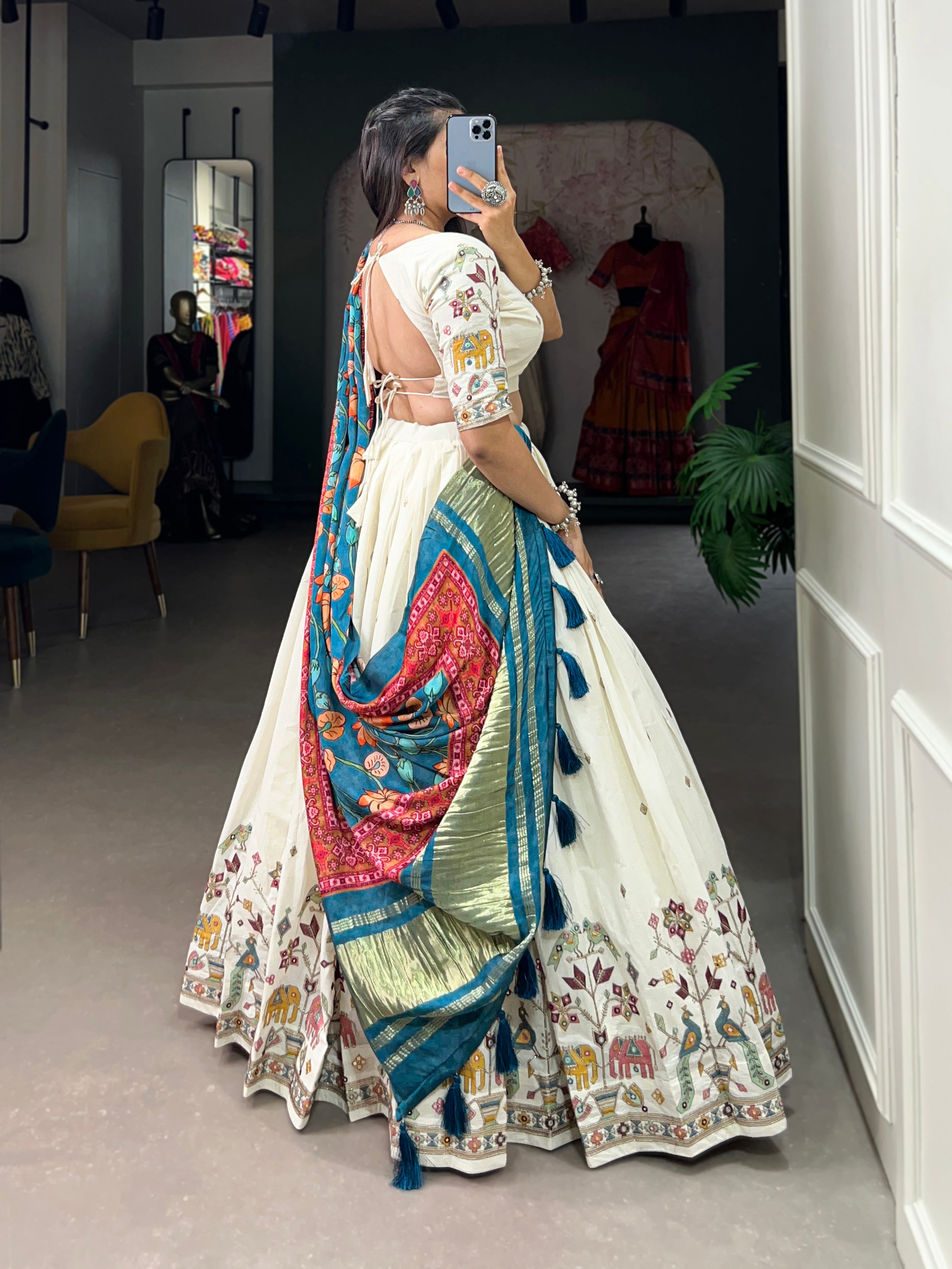 An elegant ivory lehenga made vibrant by a stunning multi-hued pink dupatta