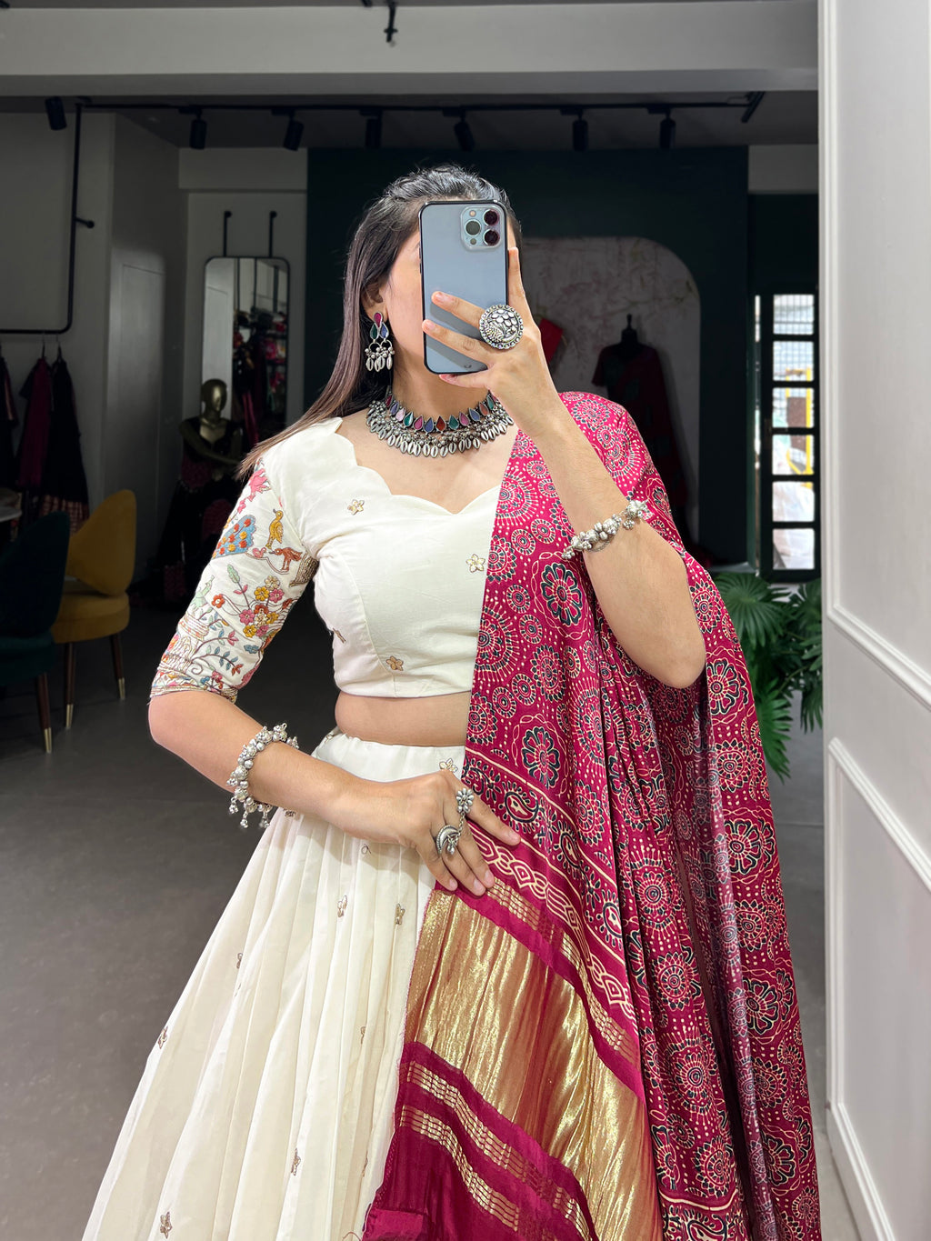 An elegant ivory lehenga made vibrant by a stunning multi-hued pink dupatta