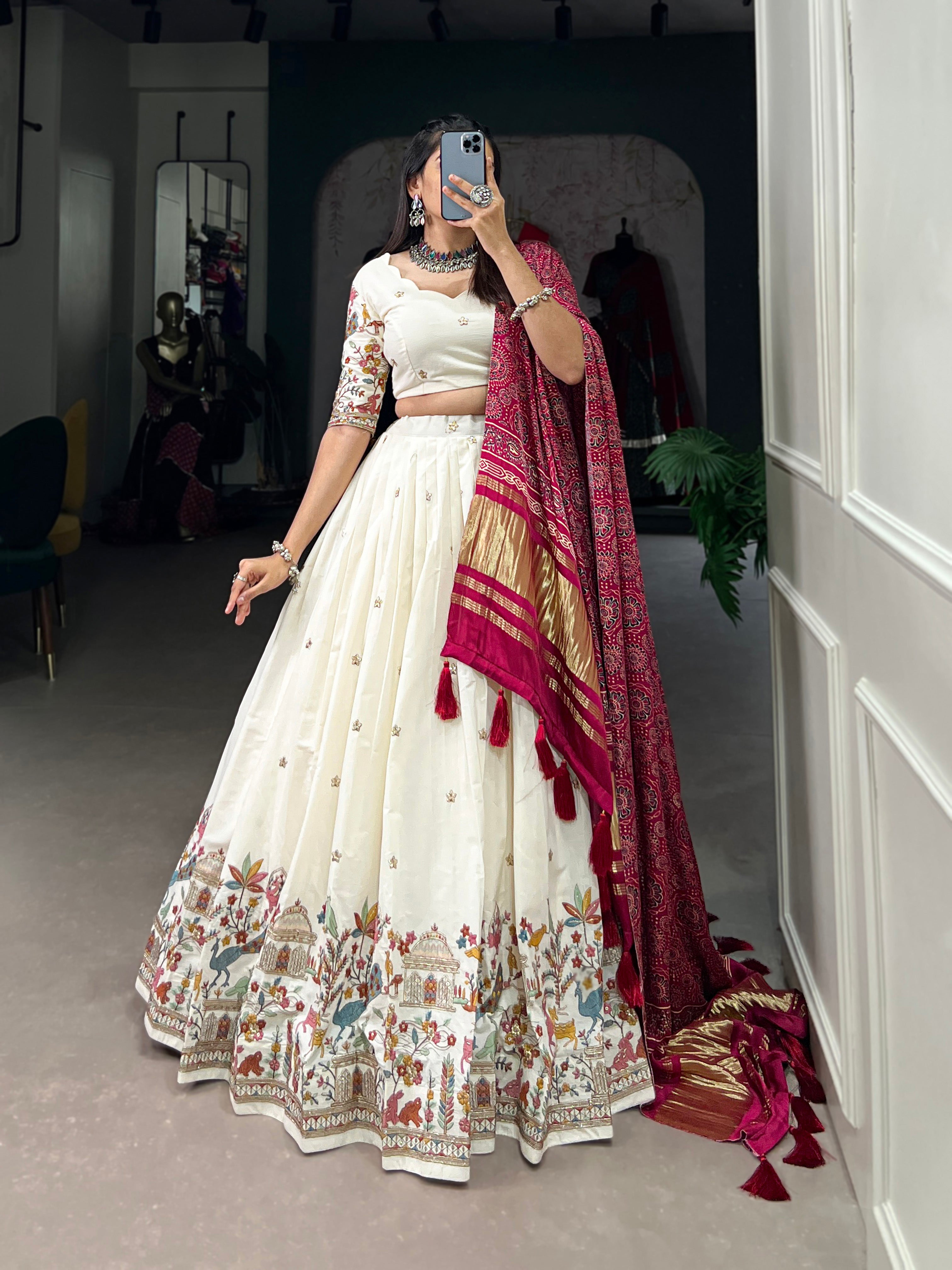 An elegant ivory lehenga made vibrant by a stunning multi-hued pink dupatta