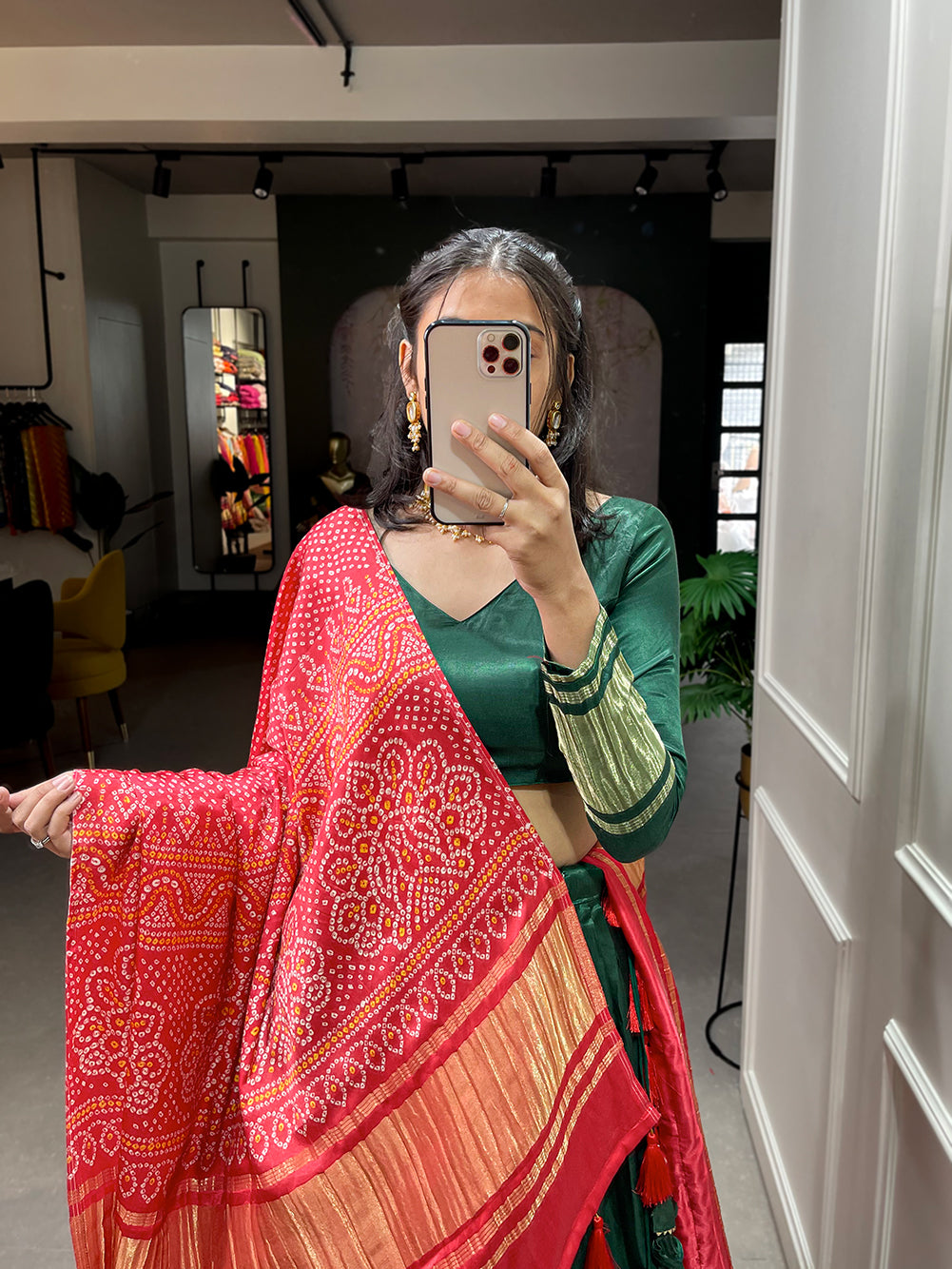 Elegant green lehenga with a vibrant coral dupatta