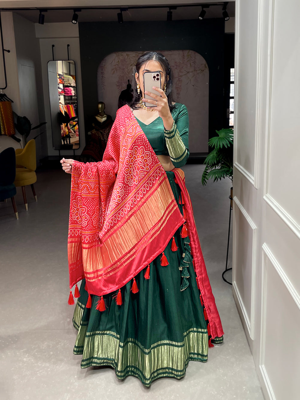 Elegant green lehenga with a vibrant coral dupatta