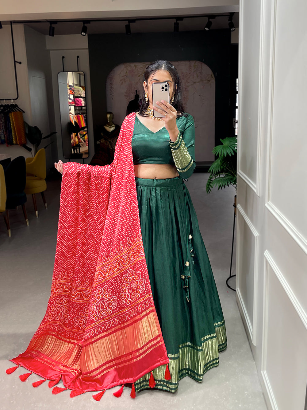Elegant green lehenga with a vibrant coral dupatta