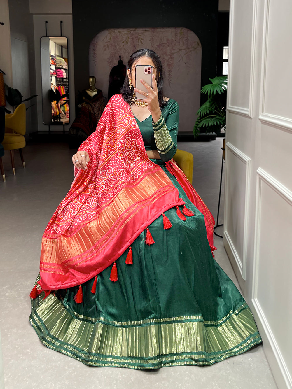 Elegant green lehenga with a vibrant coral dupatta