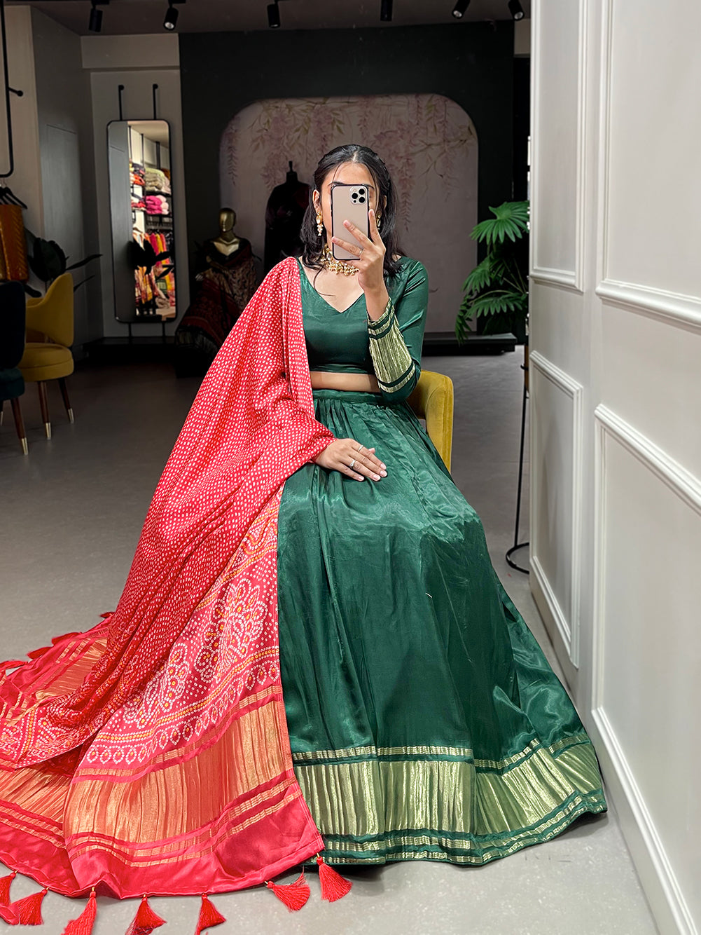 Elegant green lehenga with a vibrant coral dupatta
