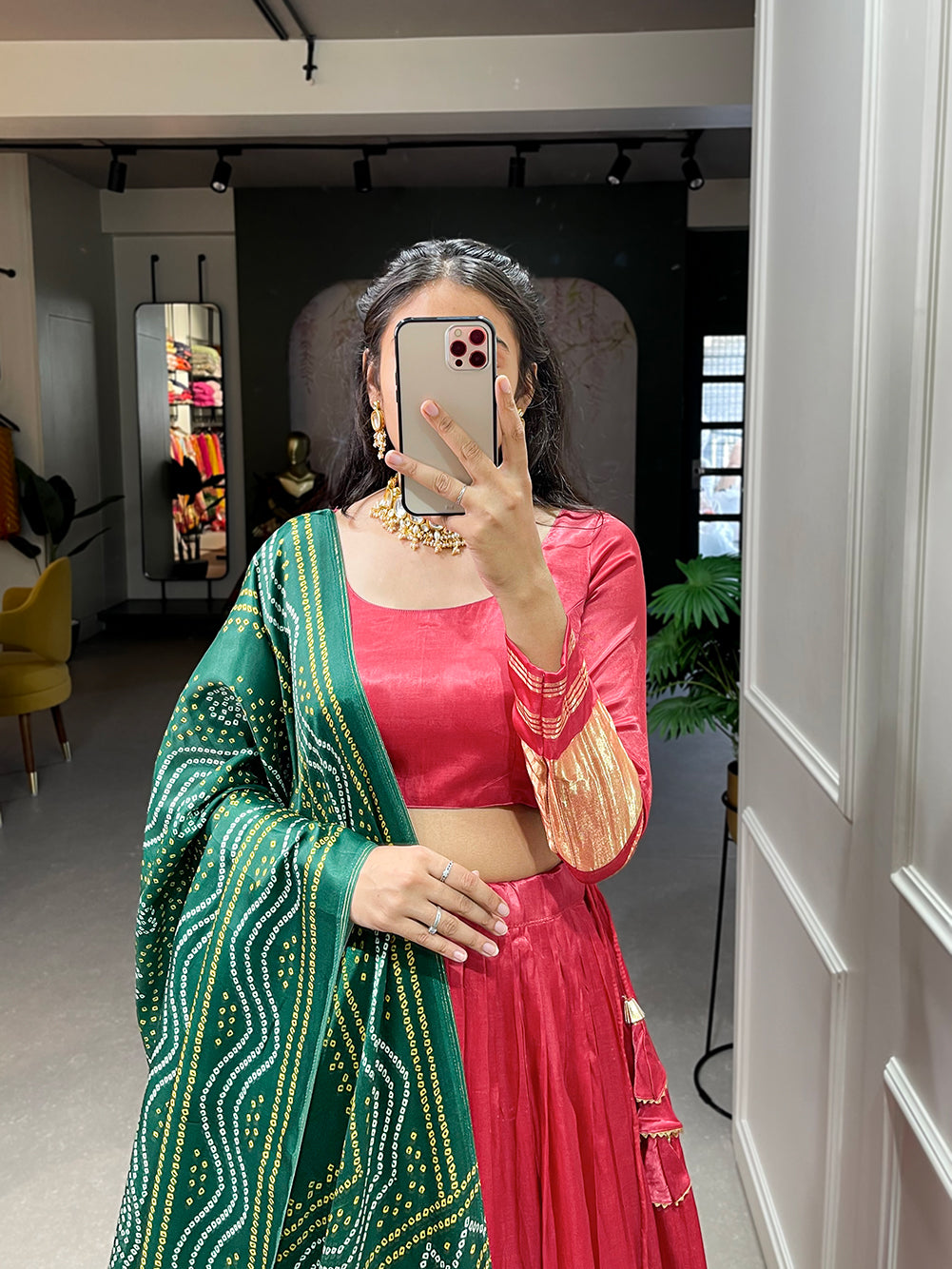 Elegant green lehenga with a vibrant coral dupatta