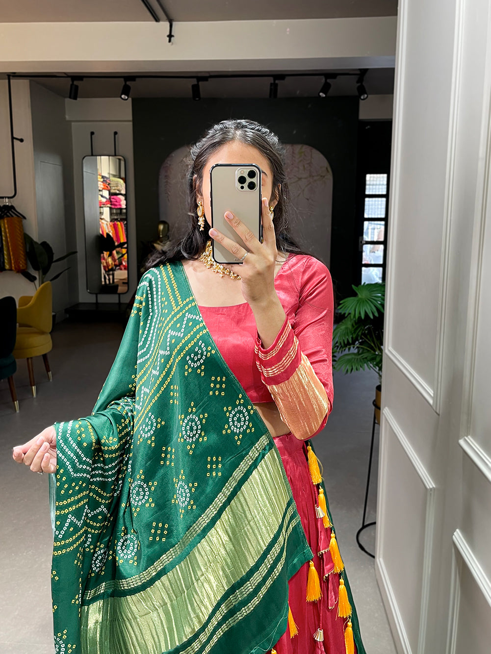 Elegant green lehenga with a vibrant coral dupatta