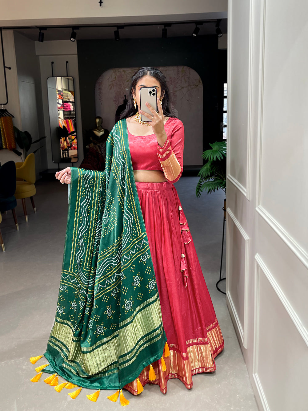 Elegant green lehenga with a vibrant coral dupatta