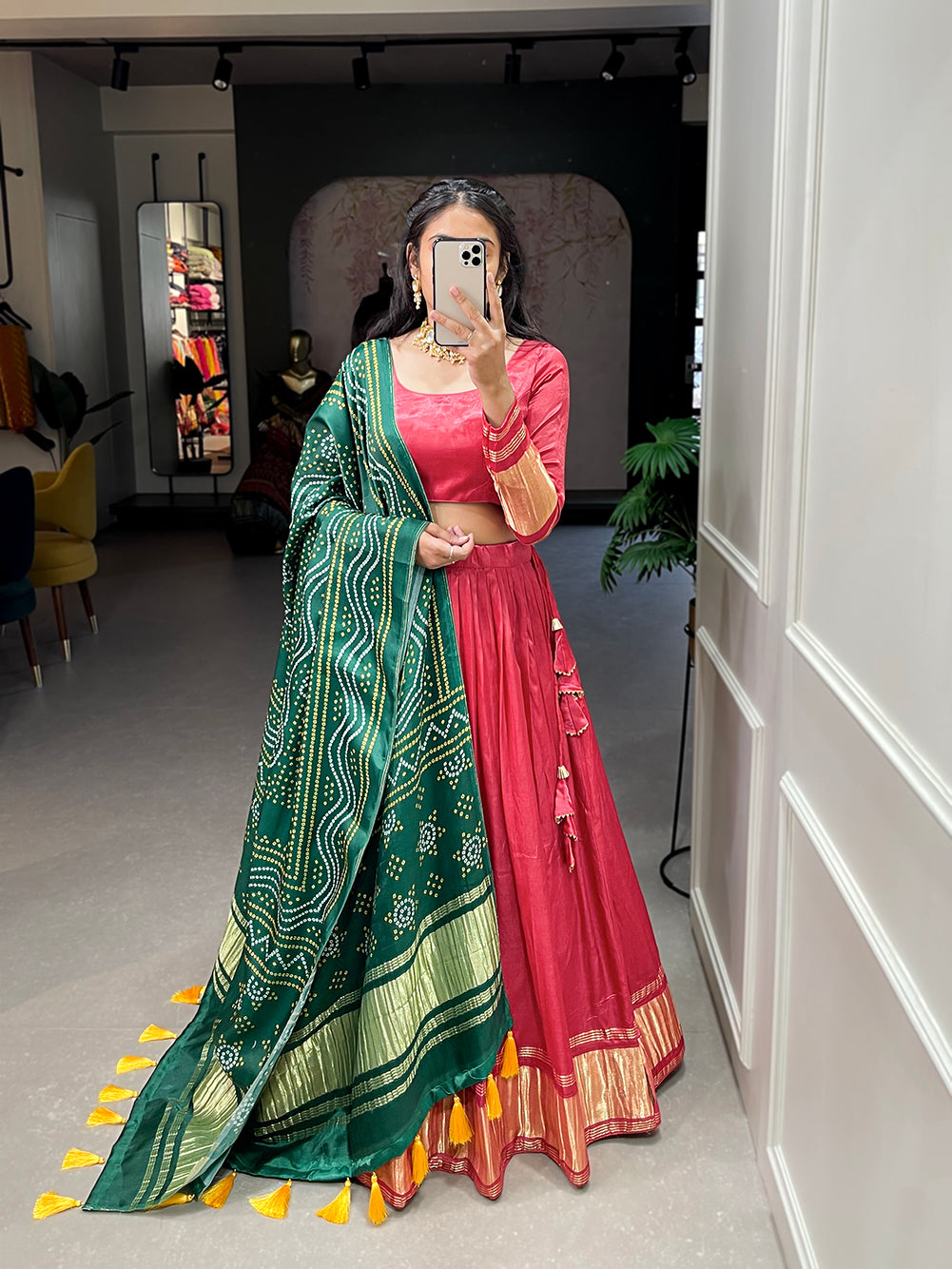 Elegant green lehenga with a vibrant coral dupatta