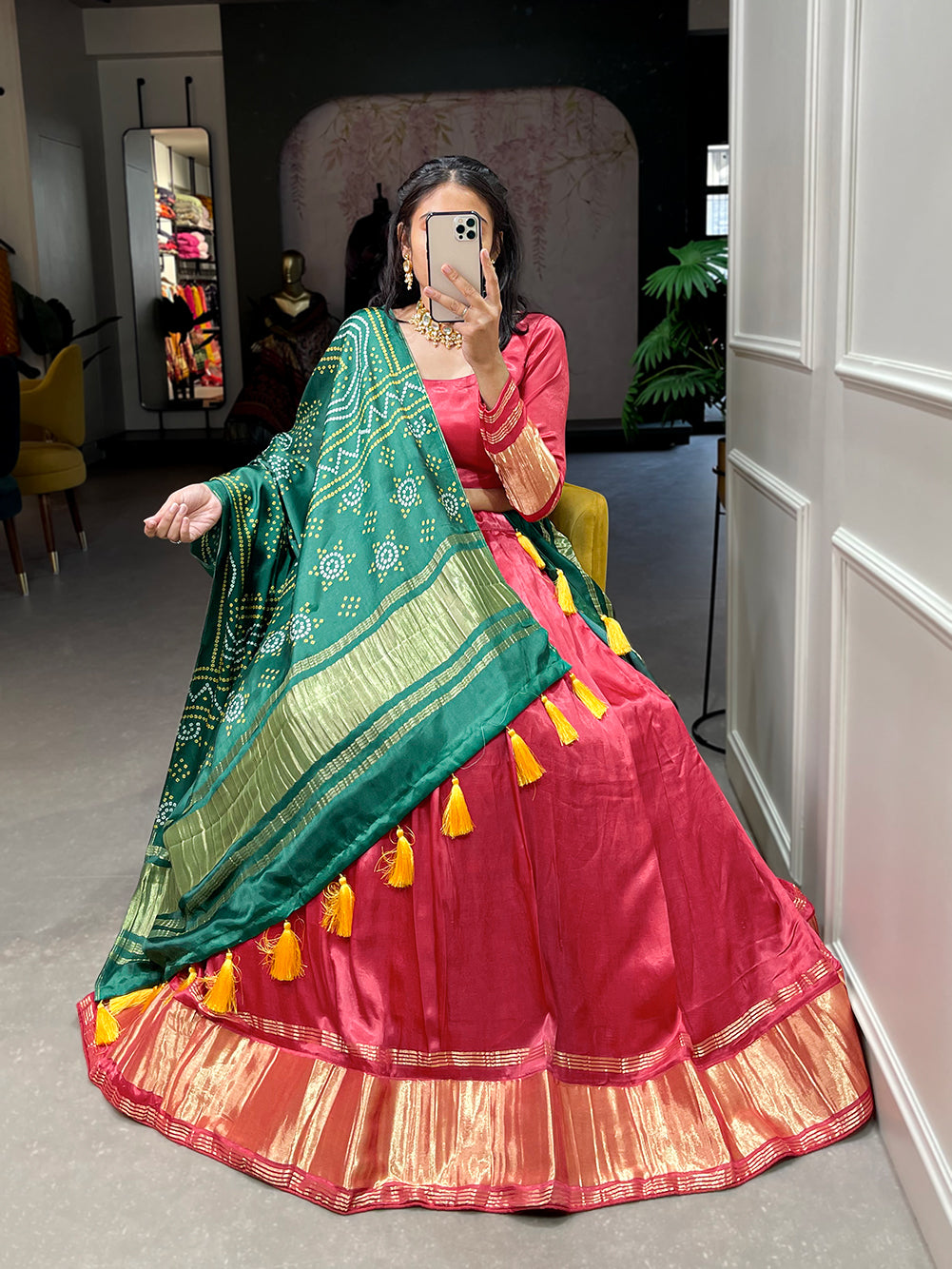 Elegant green lehenga with a vibrant coral dupatta