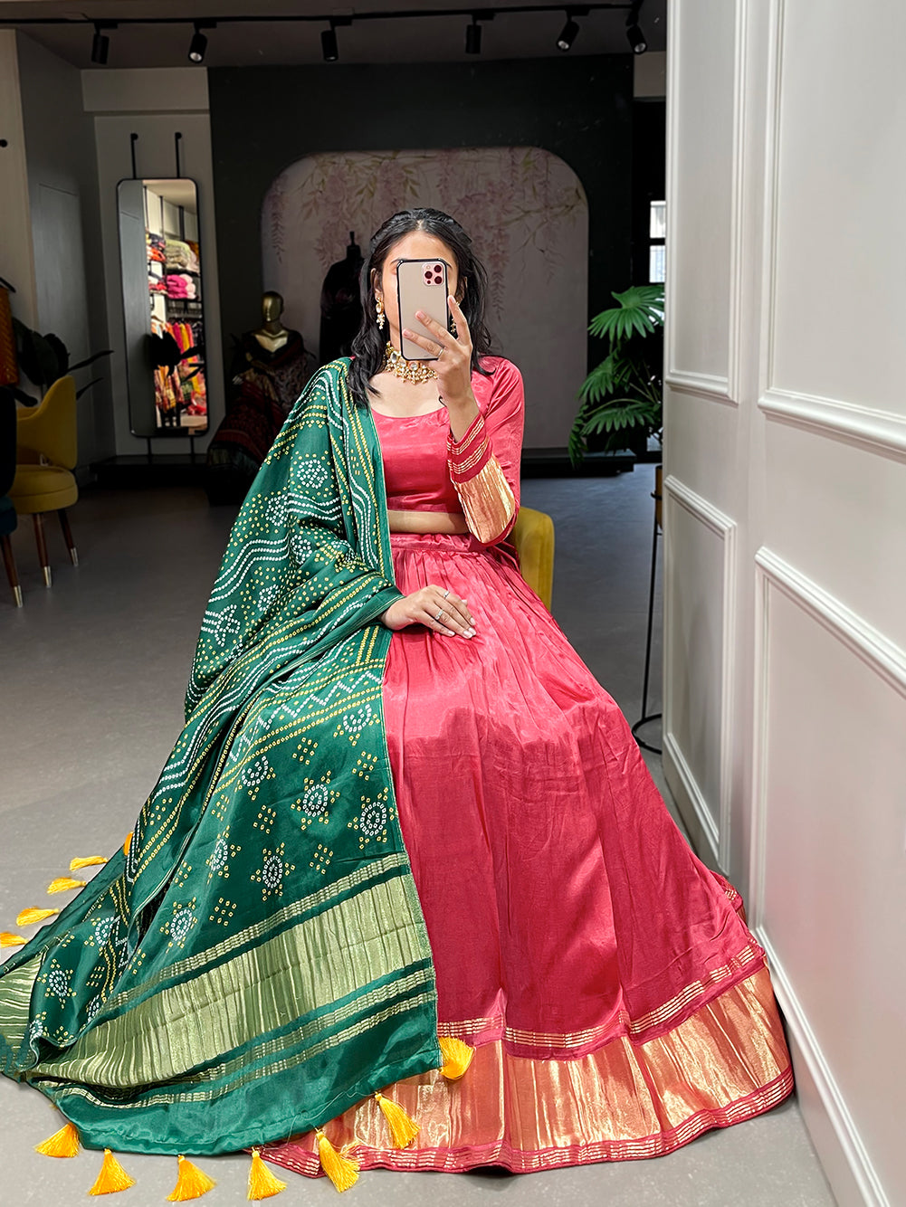 Elegant green lehenga with a vibrant coral dupatta