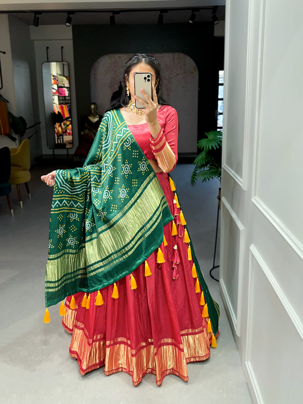 Elegant green lehenga with a vibrant coral dupatta