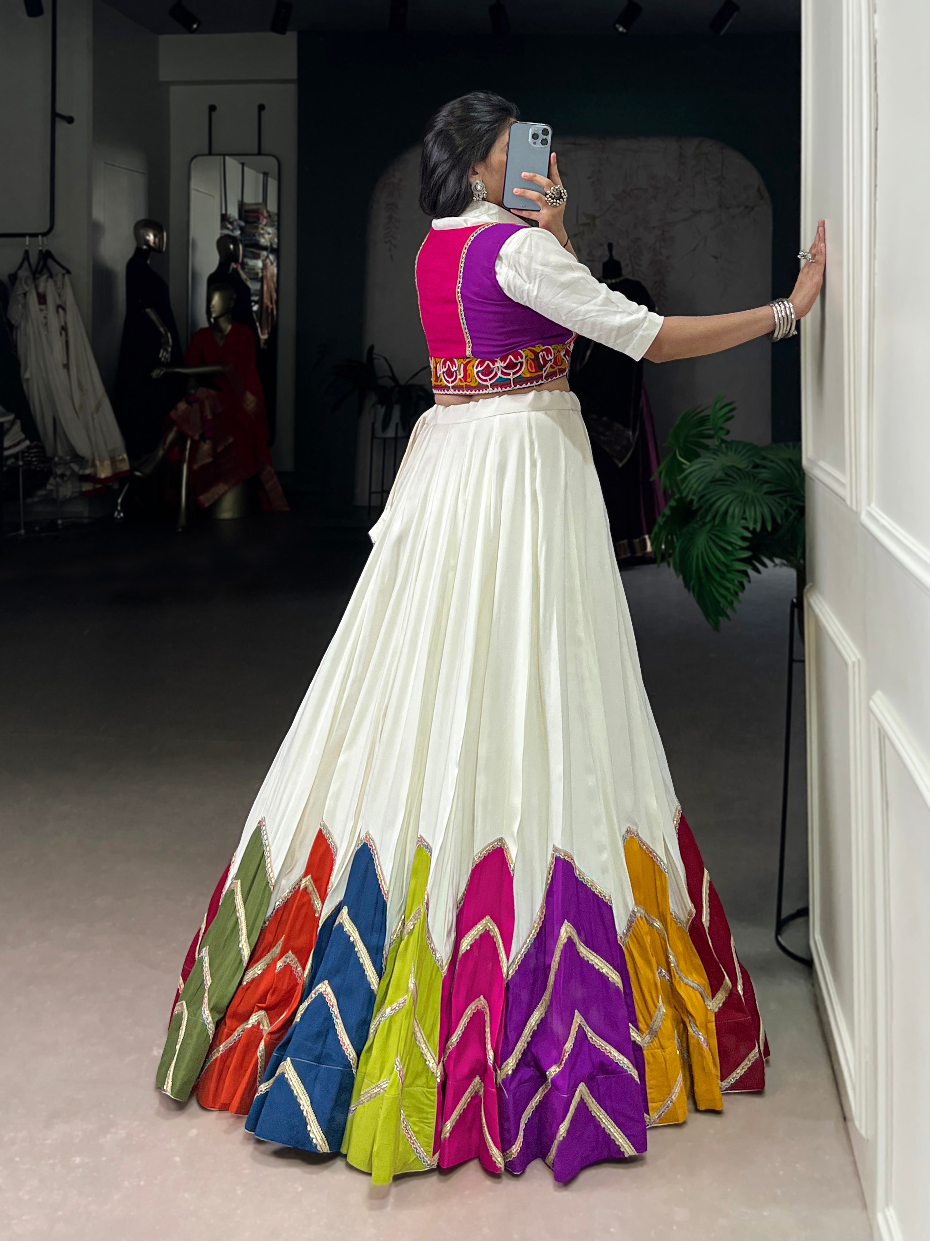 Designer White Lehenga Paired with Colorful Blouse and Border Detailing