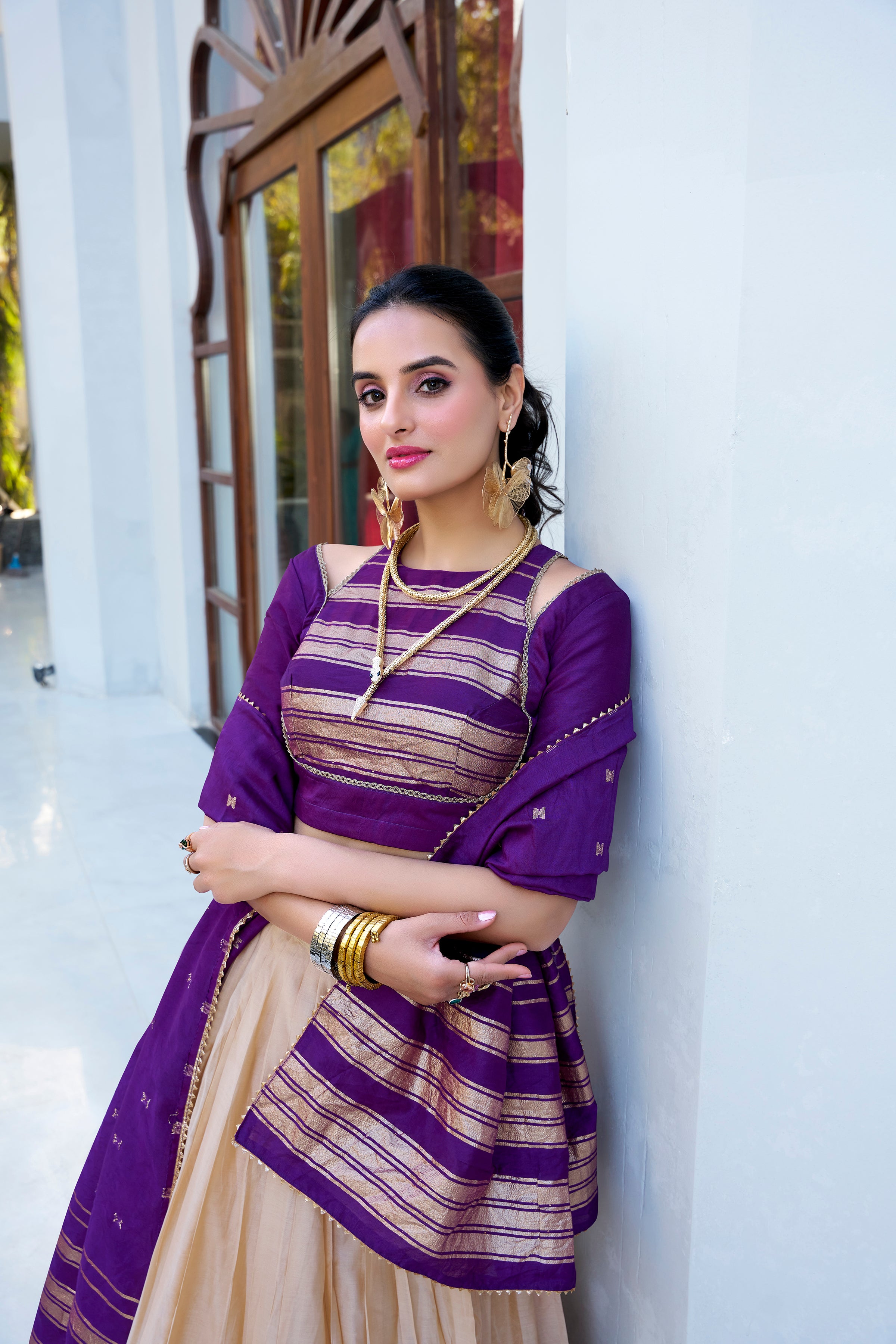 Regal sophistication in a stunning cream and purple lehenga.