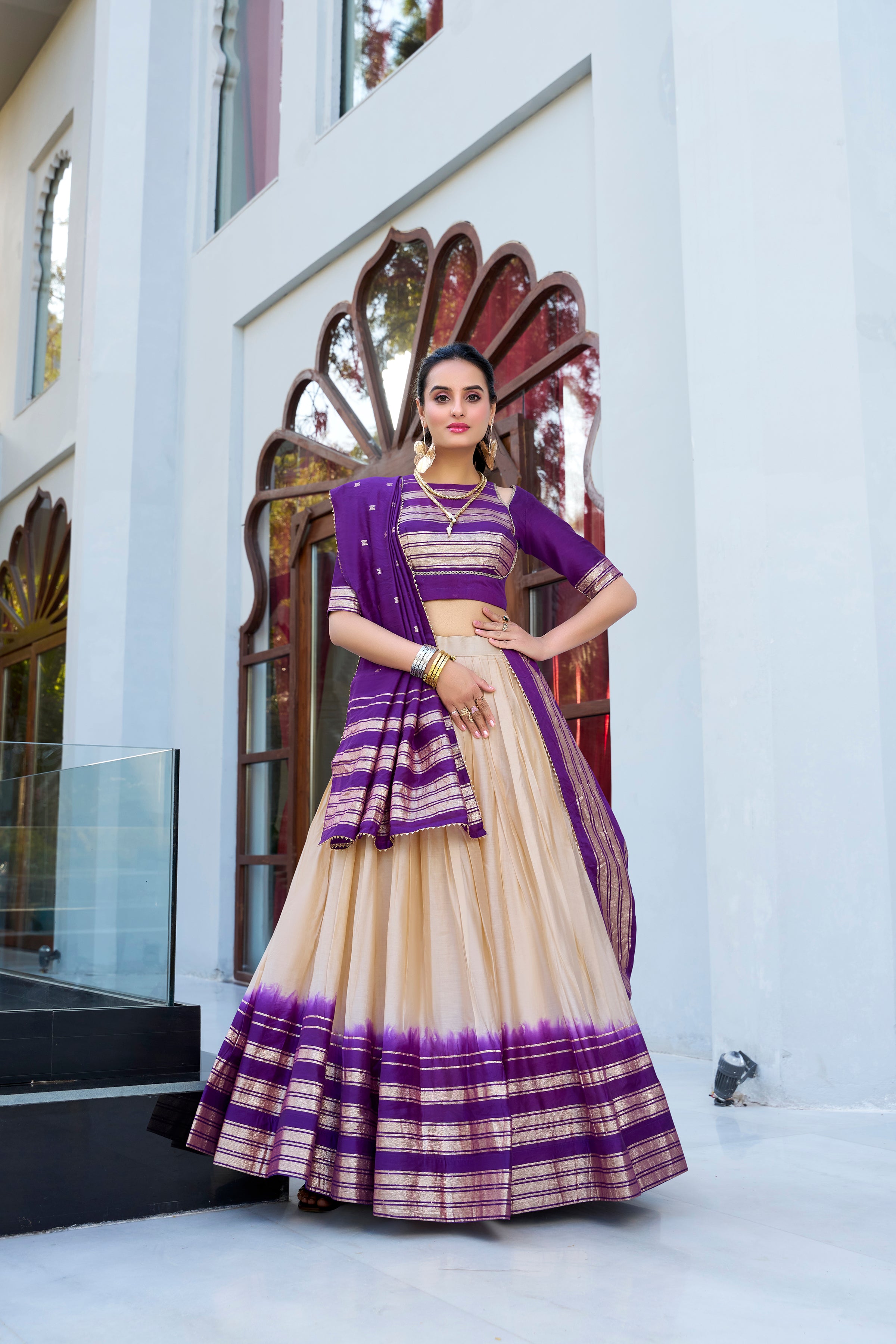Regal sophistication in a stunning cream and purple lehenga.