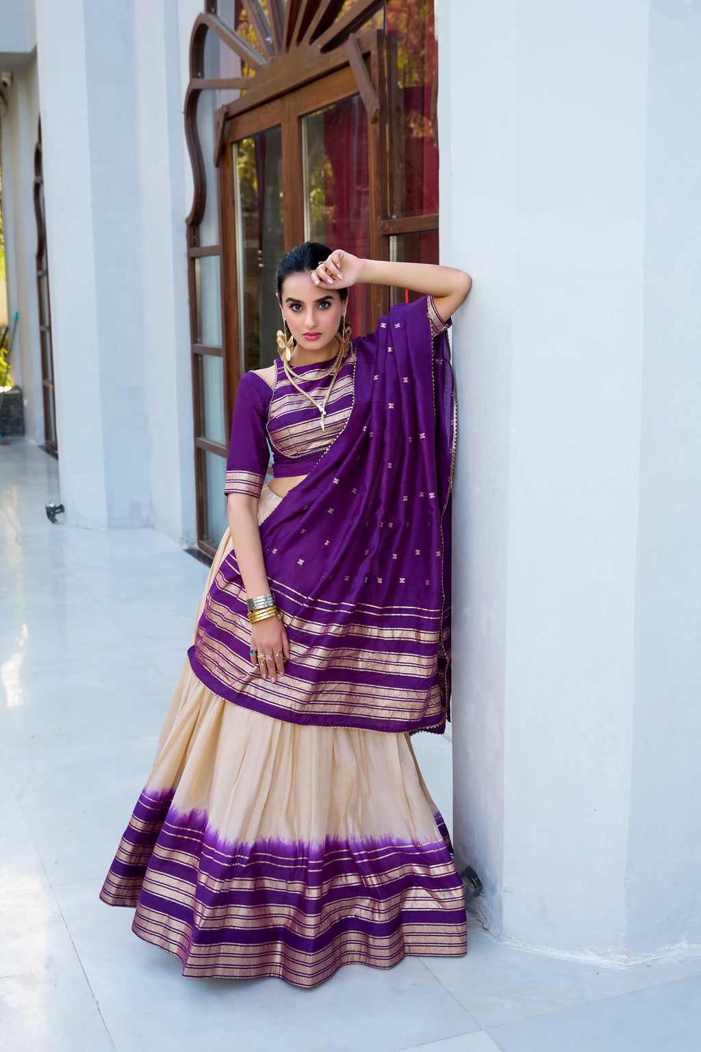 Regal sophistication in a stunning cream and purple lehenga.