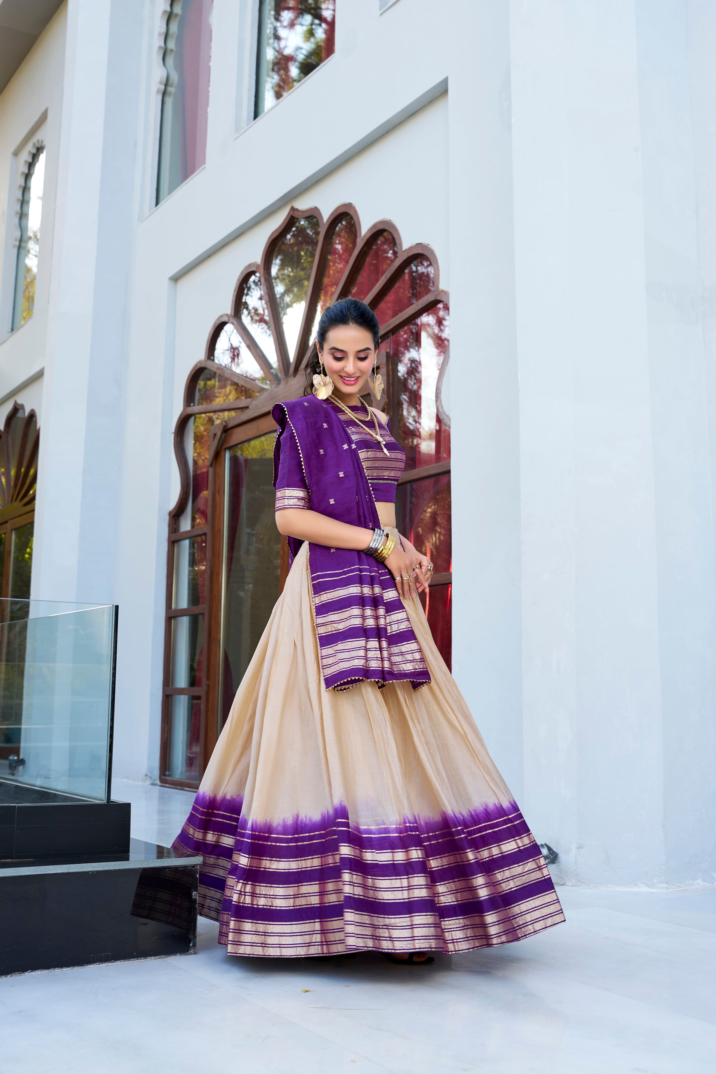 Regal sophistication in a stunning cream and purple lehenga.