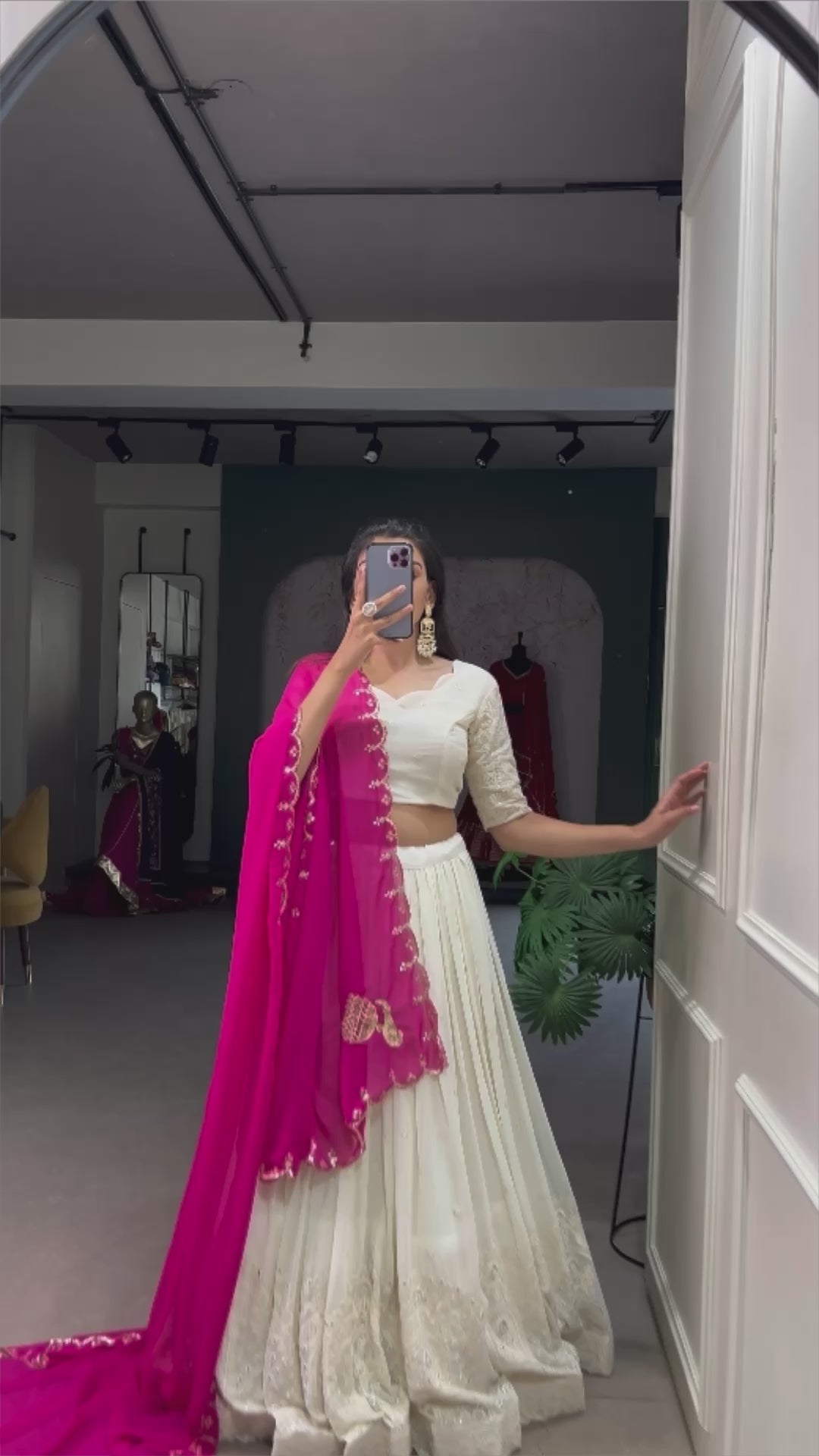 An elegant white lehenga made regal with a vibrant purple dupatta.
