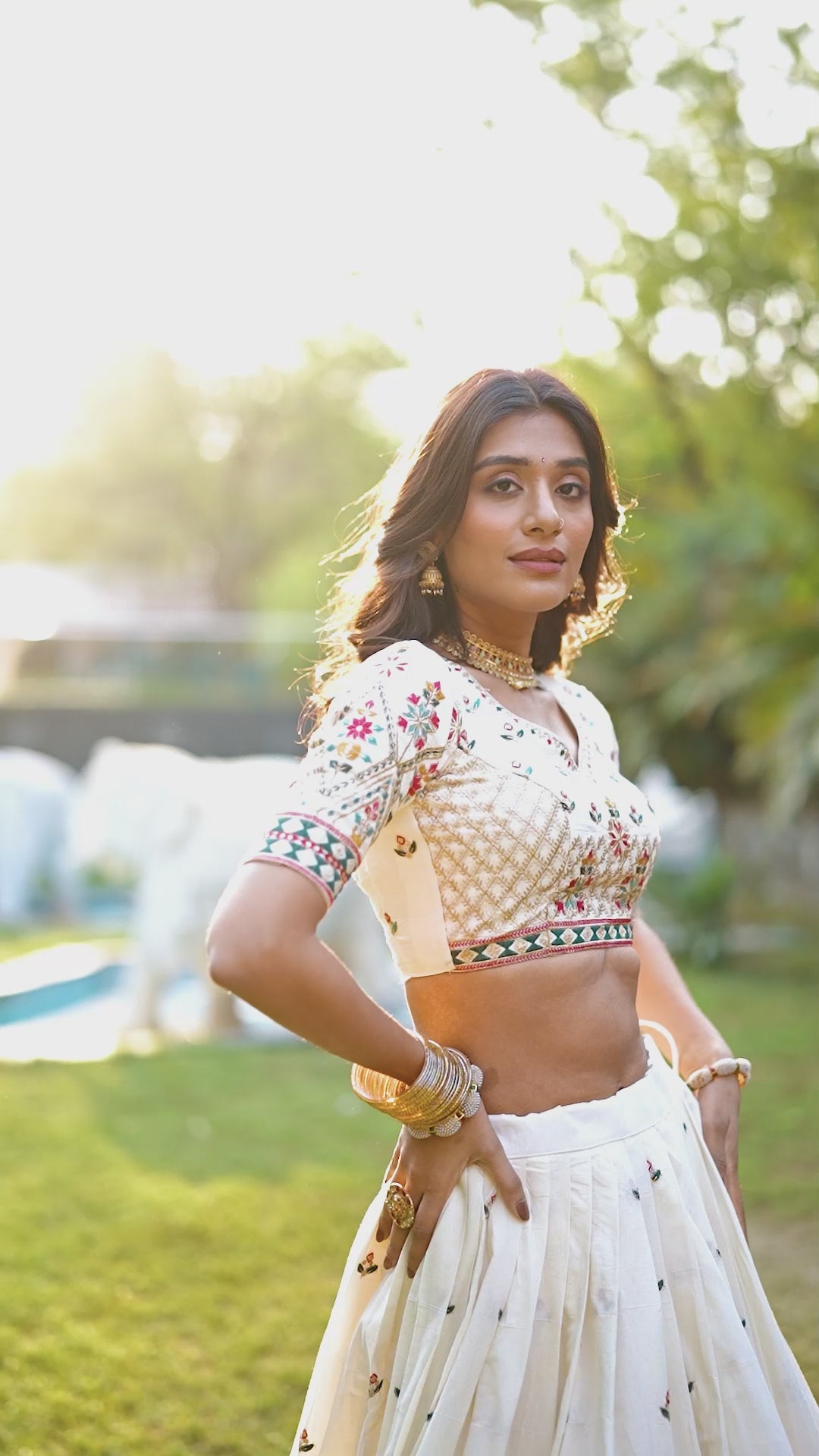 A vision of grace in an ivory lehenga adorned with peacock motifs.