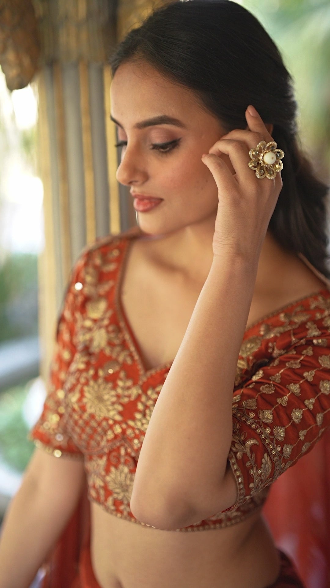 A vision of timeless elegance in a radiant rust-orange lehenga.