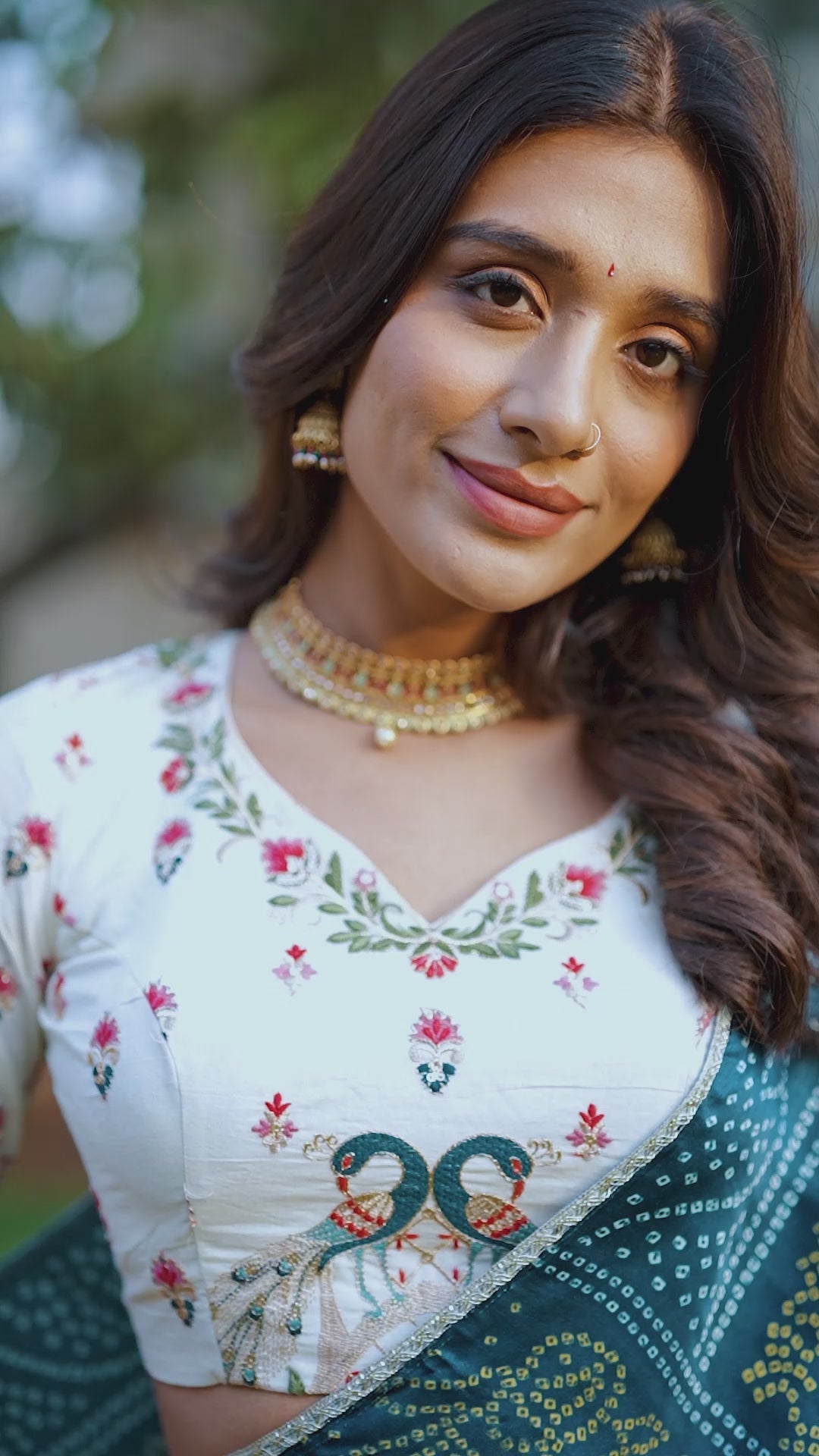 A vision of grace in an ivory lehenga adorned with peacock motifs.