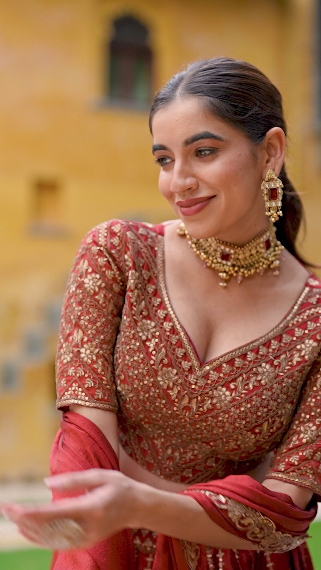 A captivating vision in a deep crimson and gold lehenga.
