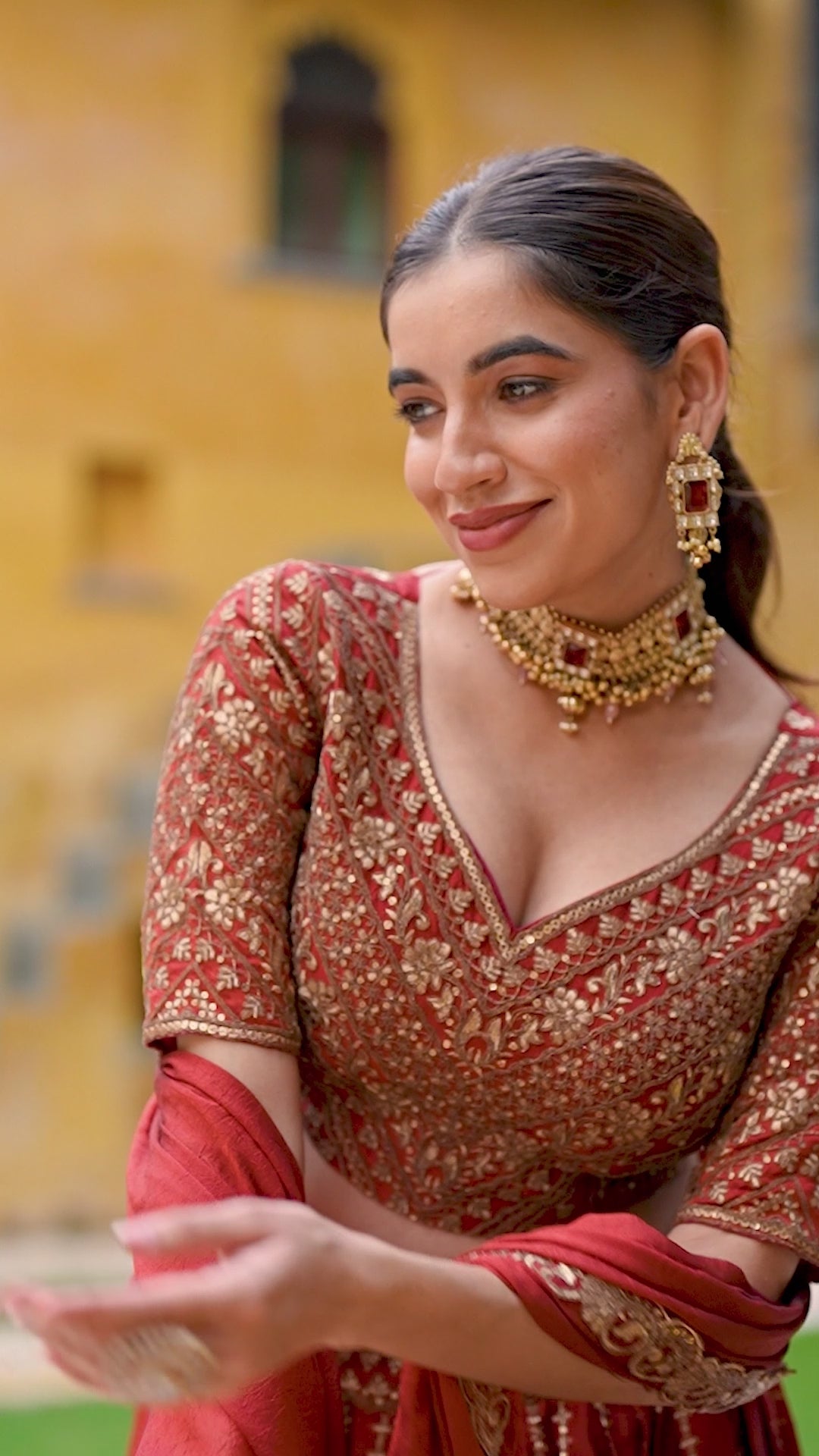 A captivating vision in a deep crimson and gold lehenga.