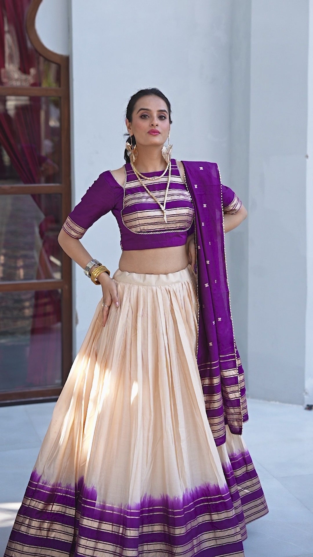Regal sophistication in a stunning cream and purple lehenga.